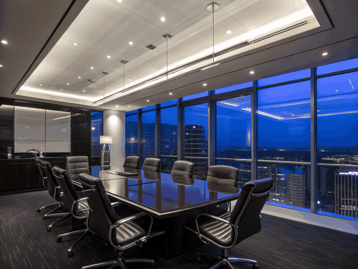 A high-end executive boardroom overlooking a city skyline at sunset